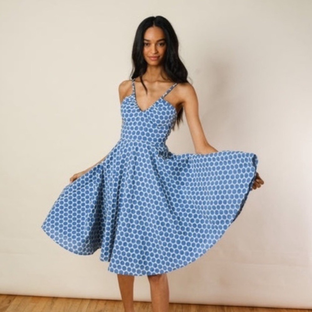 This adorable fit and flare dress has spaghetti straps a fitted waist & pockets!